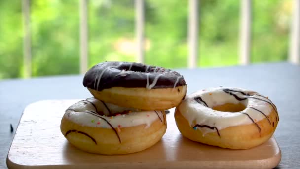 One Chocolate and Two White Frosted Donuts on Tray - Unhealthy Diet — Stock Video