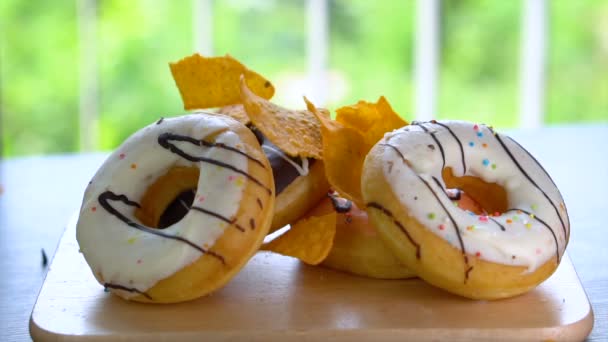 Unhealthy Food - Tortilla Chips Falling Down on Donuts — Stock Video