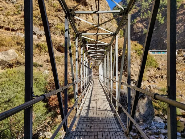 Suspension bridge connecting two villages in remote part of Nepal
