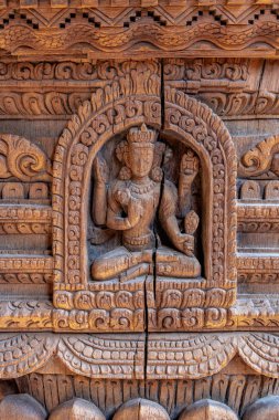 Detailed wood carvings of Hindu Gods and sculptures on ancient temples of Nepal. clipart
