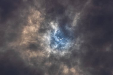 Surreal Dramatic Solar Eclipse Covered By Clouds. Natural Phenomenon. clipart