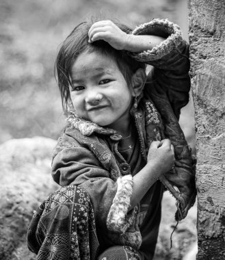 Samagau, Gorkha - December 23 2018: Young beautiful sherpa girl poses infront of the camera. clipart