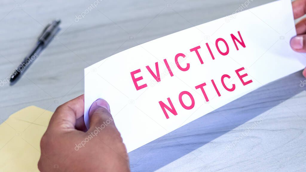 Hands of a man holds eviction notice letter