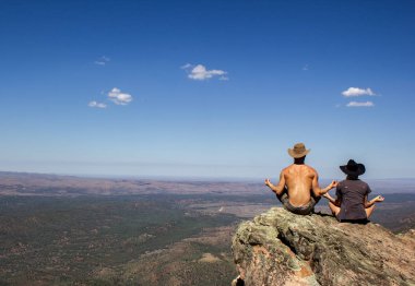 jung women and men sitting on St Mary's Peak from the Flinders Ranges National Park, Australia clipart