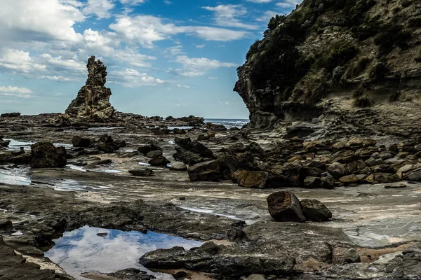 sharp and rough cliff rocks emerging from the water of the Australian coast line, Vicotira, Australia