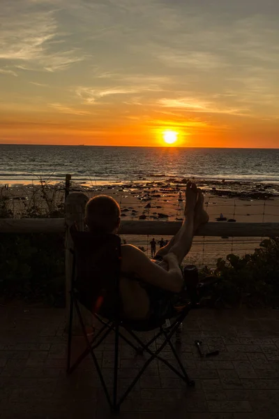 Adam akşam yemeği, Broome, Batı Avustralya sahip Günbatımı ile tatil in sandalye kumsalda dinlenmek