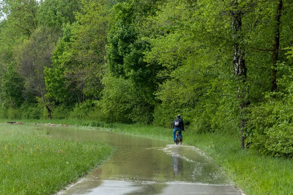 stock image munich, isar, brudermuehlbruecke, Mai 22, 2019: storm deep axel is flooding the isar in munich, bikers trying to cross the flooedes bike ways