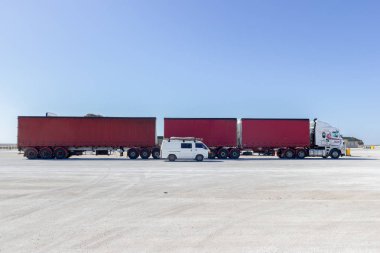 white van parking next to a Road train, the Nullabor Dessert