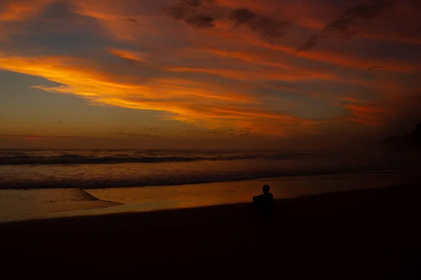 Young man sitting outdoors watching the sunset. Thinking and relaxing concept, Australia — Stock Photo, Image