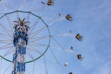 Munich, Germany - 2019, September 19: people on a tallest kettenkarussell at the biggest folk festival in the world - the octoberfest