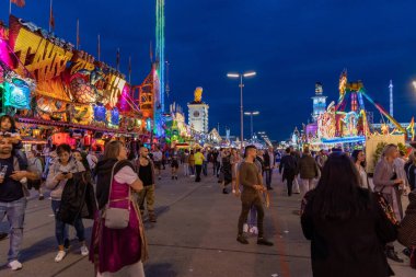 Munich, Germany -2019  September 24: visitors, beertents and candy shops on the oktoberfest in munich at night