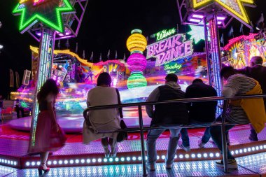 Munich, Germany, 2019 September 24: Visitors enjoy the view of an Amusement Park Ride at night. Breakdancer fun Ride, Oktoberfest, Bavaria