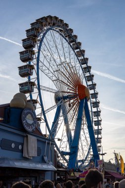 Munich, Germany - 2019, September 28: visitors from all over the world walking in front of the ferris wheel at the Oktoberfest in Munich