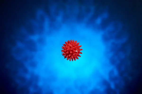 Beautiful red massage ball with spikes for stimulation and circulation, hangs in the air on the dark blue background. relaxation, health. Thematic and subject-matter shooting. bacterium.