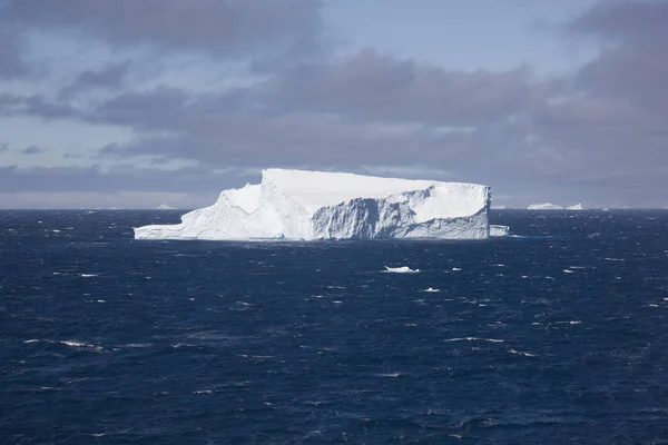 Antarctic landscape with blue icebergs and the ocean on a sunny day