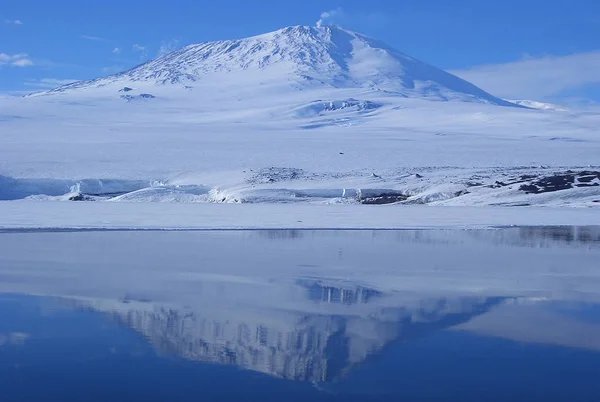 Beautiful Antarctic landscape with ocean, icebergs and reflection on a sunny day