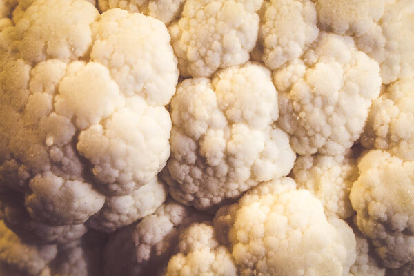 Fresh white cauliflower on a wooden board closeup for you