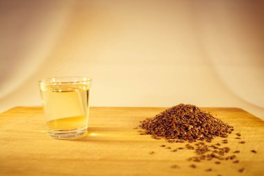 Keten tohumu avuç, keten tohumu yağı bir bardak masanın üzerine