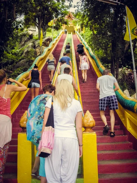 People climb up the red stairs up in Thailand