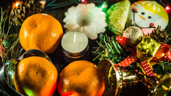 Candle not lit. Around tangerines, candles, garland, cookies and Christmas tree