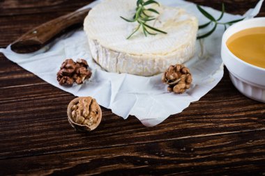 Camembert cheese with nuts and  honey. Selective focus clipart