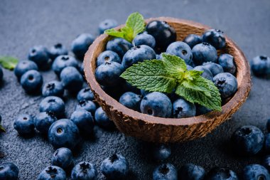 Karanlık bir arka plan üzerinde ahşap kase taze yaban mersini. sağlıklı beslenme kavramı 