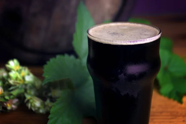 Pinka tmavé pivní pěny nádherně na hlavni s listovou tapetu — Stock fotografie
