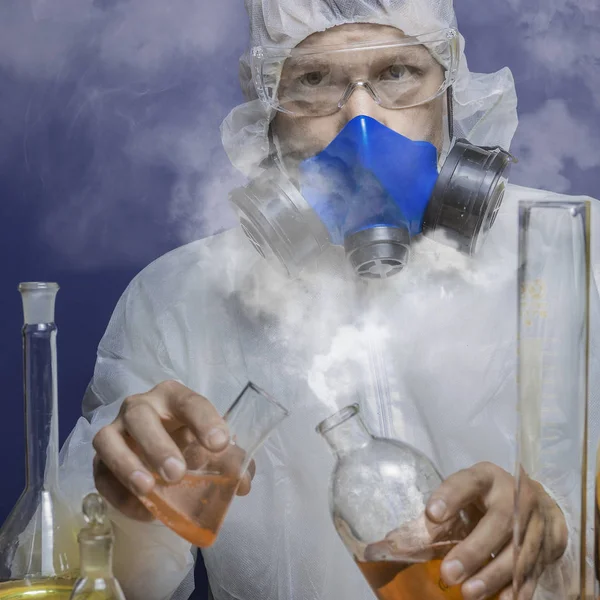 Scientist in gas mask holding test tube with dangerous substance, biohazard — Stock Photo, Image
