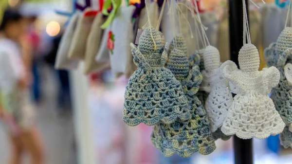 Photo Handmade toys in the shape of an angel hang on strings. Blurred background. — Stock Image Photo Handmade Toys Shape Angel Hang Strings Blurred Background Stock Picture