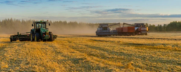 Agricultural machine for harvesting crops in the fields, special equipment in action. agricultural machinery in the field. Heavy equipment, sunset