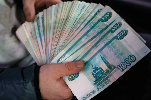 Rus para büyük bir demet elini sıktı.