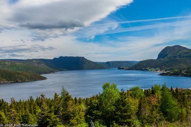 Beautiful Gros Morne scenary of mountains, water and cluds clipart