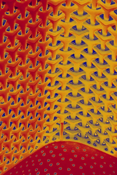 Mehrdimensional verwobenes Hintergrundmuster in tiefrot, gelb und blau — Stockfoto