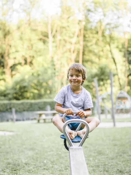 Blonder Junge Hat Spaß Beim Sitzen Auf Schaukel Auf Spielplatz — Stockfoto