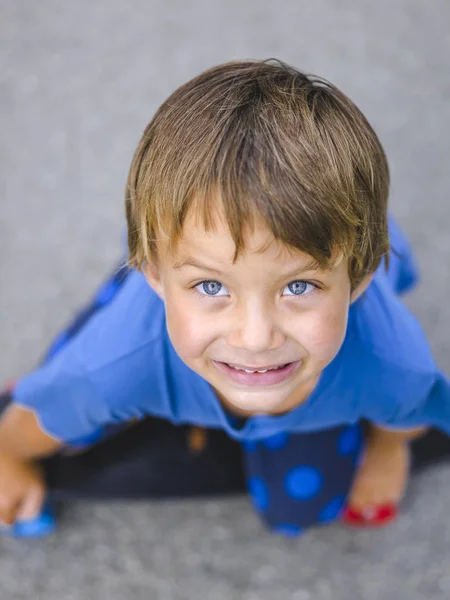 Niño Rubio Con Monopatín Sentado Asfalto Mientras Juega Patio Recreo —  Fotos de Stock