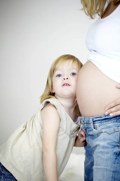 Daughter Listening Belly Pregnant Mom Stock Photo