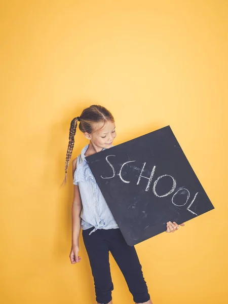 Όμορφη Κοπέλα Κρατώντας Μαυροπίνακας Κείμενο Σχολείο Και Ποζάρουν Μπροστά Πορτοκαλί — Φωτογραφία Αρχείου