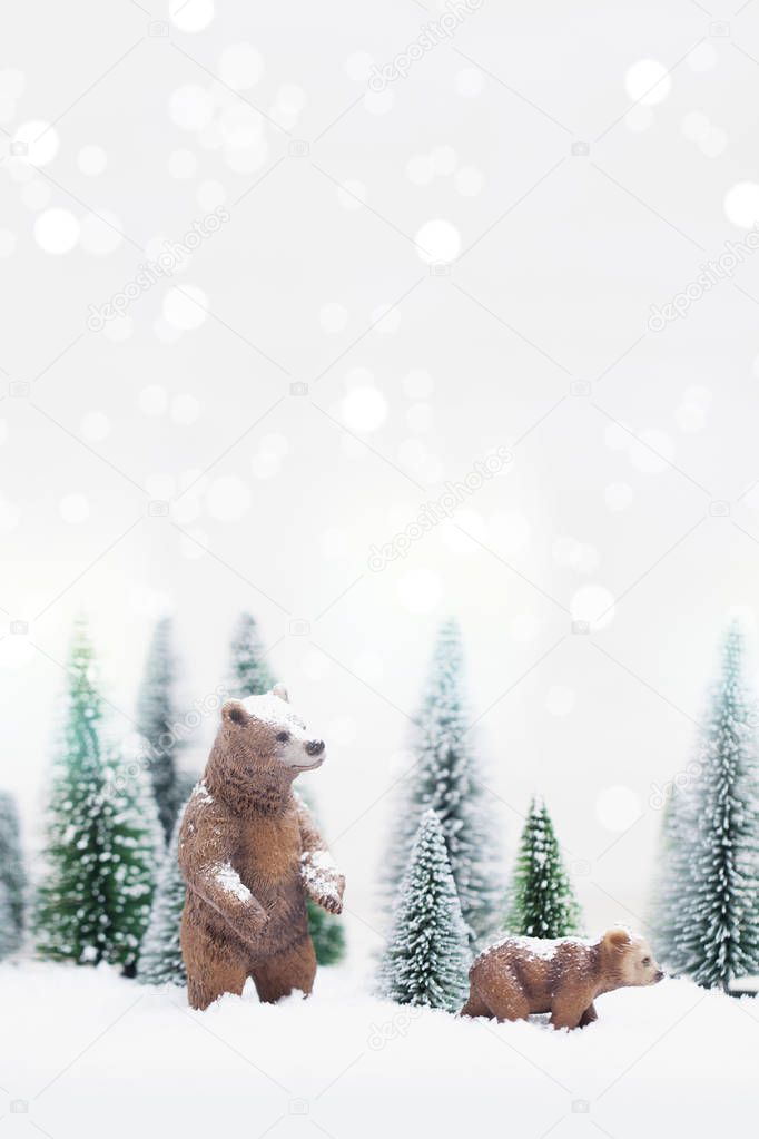 miniature of Christmas grizzly bears toys in Snowy Winter Forest, background for Christmas card