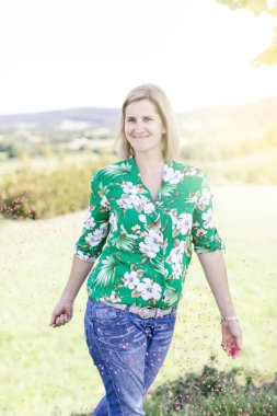 Mutlu memnun kadın yaz güneşli gün çayır konfeti atma