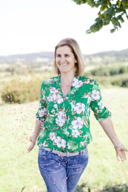 Mutlu memnun kadın yaz güneşli gün çayır konfeti atma