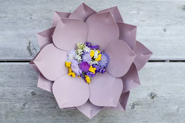 beautiful purple floral bowl with flowers on wooden background