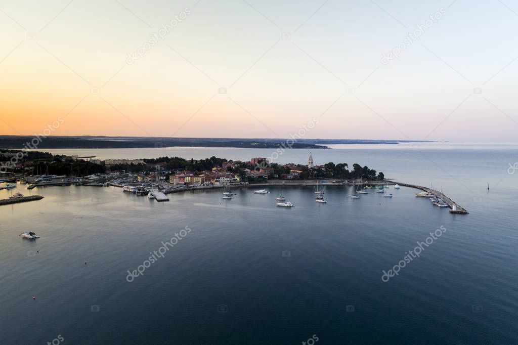 aerial drone view of sunrise over port with yachts in novigrad 