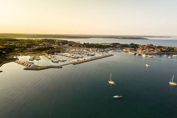 aerial drone view of sunrise over port with yachts in novigrad 