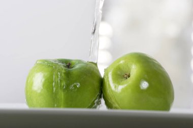 Olgun yeşil elma dökülen su yakın çekim  