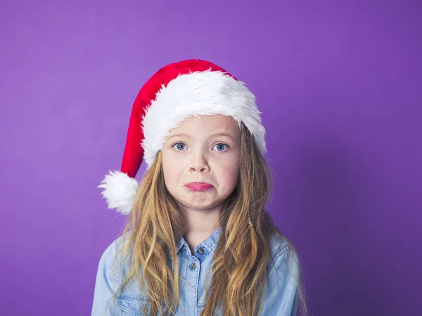 Szomorú Érzelmi Kislány Sír Mellett Lila Háttér Előtt Piros Santa — Stock Fotó