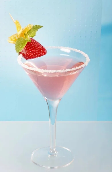 粉红色鸡尾酒在马提尼玻璃装饰草莓和橘子片与糖 — 图库照片
