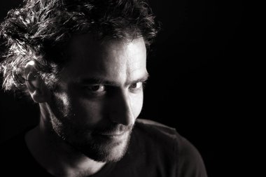 karanlık arka planda kamera bakarak yakışıklı sakallı Brunet adam portre, yakın çekim