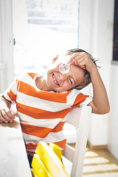 Inquisitive Little Boy Sitting Table Looking Magnifying Glass While Making — Stock Photo, Image