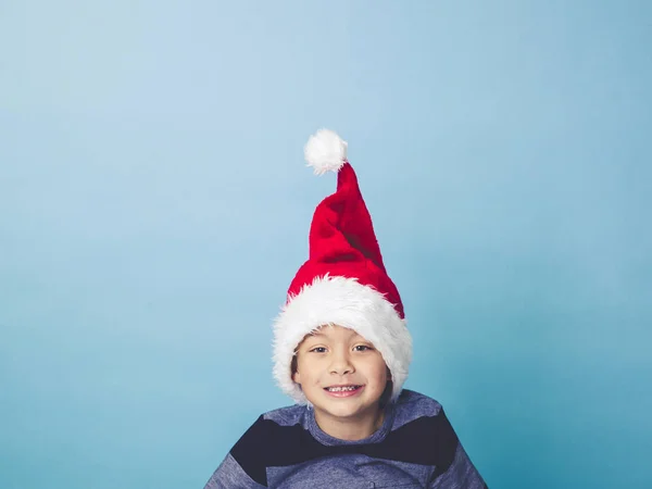 Little Boy Wearing Red Santa Hat Posing Front Blue Studio — Stock Photo, Image