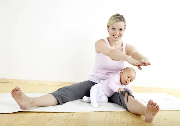 Mother Stretching Body Her Seven Month Old Baby Home — Stock Photo, Image